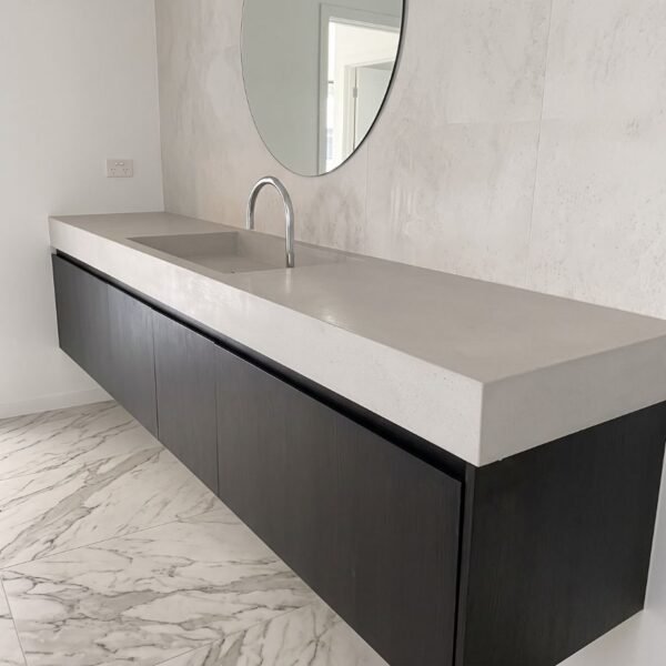 Linear Concrete Vanity Top by Slabs by Design Set in Steel